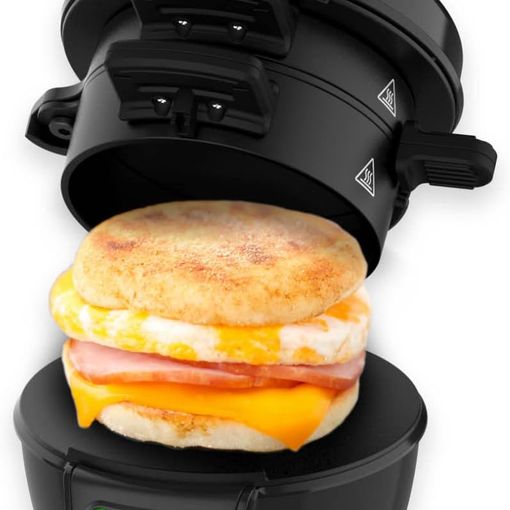 Drew&Cole electric breakfast muffin sandwich maker in black, open with a muffin, egg and bacon sandwich inside