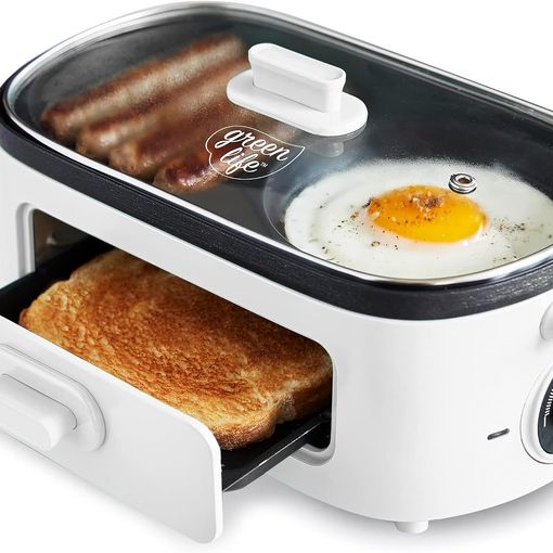 GreenLife Breakfast Maker in white with sausages and a fried egg on the ceramic griddle and toast in the drawer below