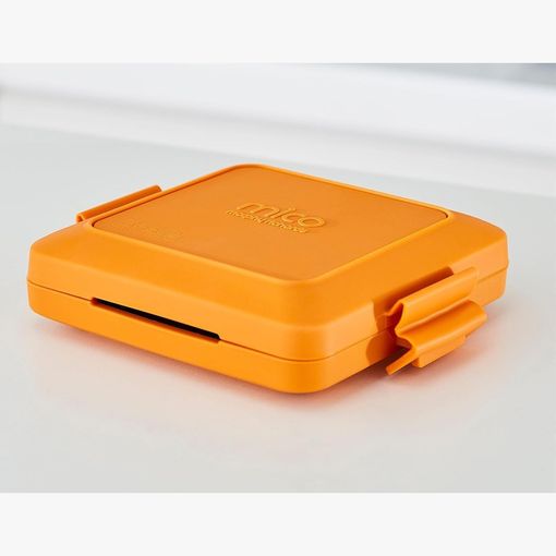 Morphy Richards Mico microwave toastie maker in orange silicone, closed, on a worktop